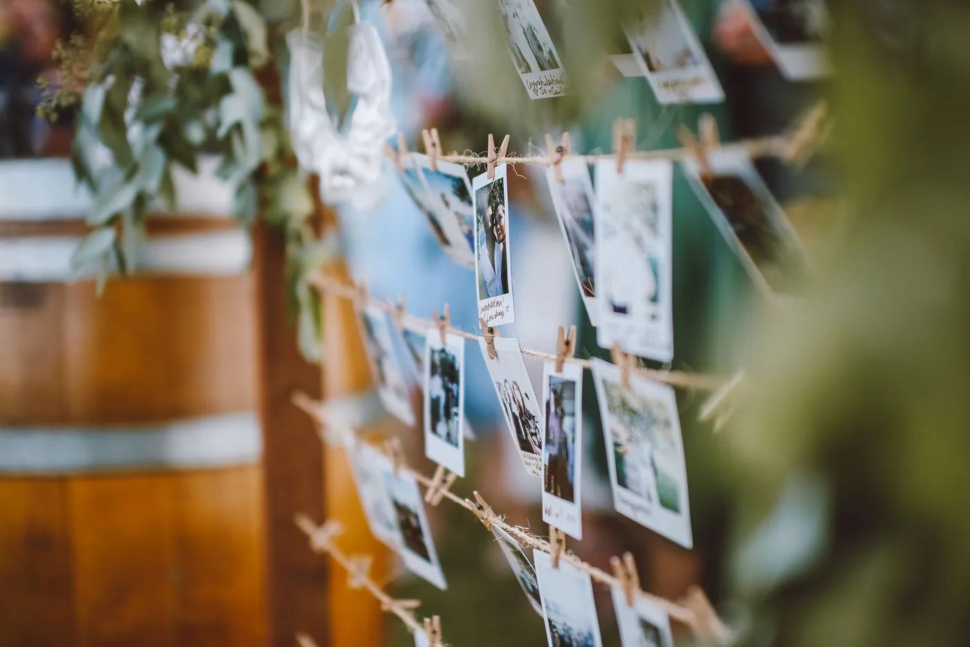 Instant photos from a wedding pegged to strings with clothespins